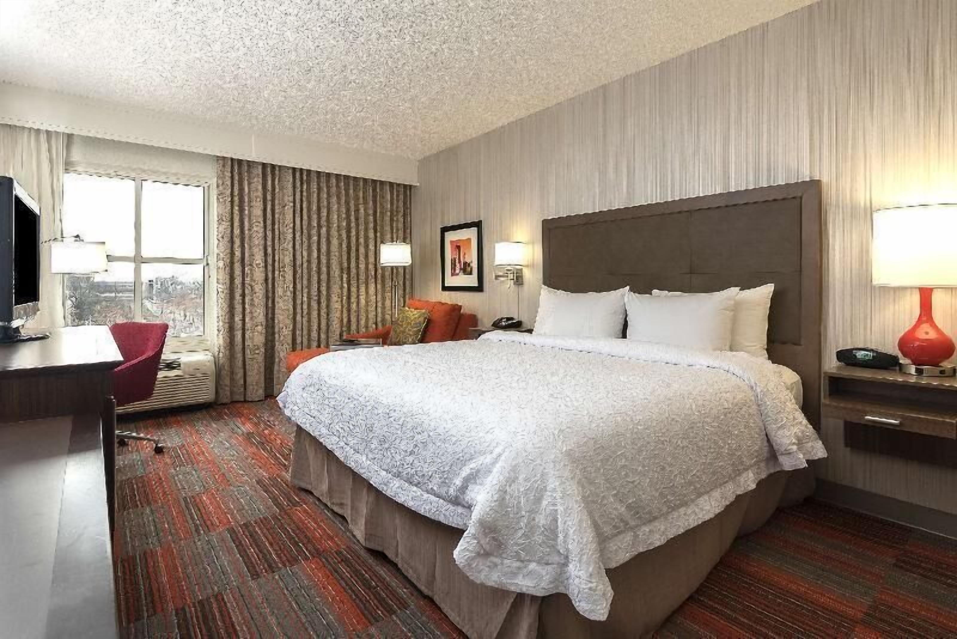 Premium bedding, desk, laptop workspace, blackout drapes