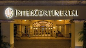 The InterContinental hotel entrance with a grand archway and illuminated signage.