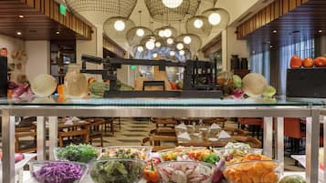 Zona de bufé con diversas opciones de comida y un mostrador de servicio central.