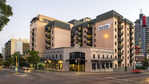 A multi-story hotel with a modern architectural design, featuring balconies and a prominent entrance. - Mantra on Hay Perth (East Perth)