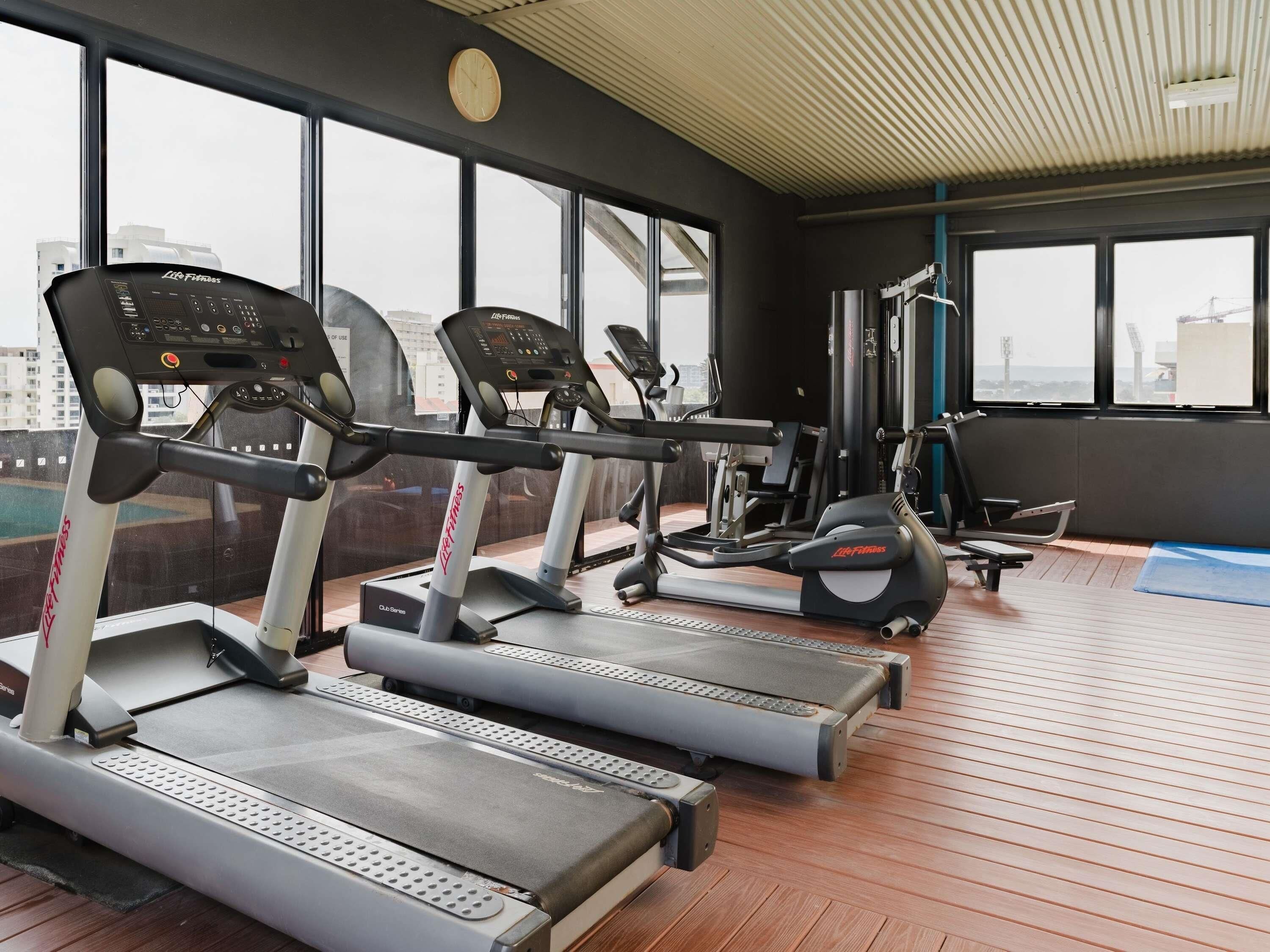 A gym with treadmills, a stationary bike, and weight machines.