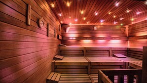 A sauna with wooden benches and a sloped ceiling. - Seaside Grand Hotel Residencia (San Bartolomé de Tirajana)