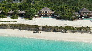 A beachfront property with a large house, a swimming pool, and multiple guest rooms. - COMO Parrot Cay (Parrot Cay)
