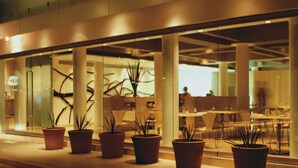 A modern building with large windows and potted plants in front. - Habita, Mexico City, a Member of Design Hotels (Mexico City)