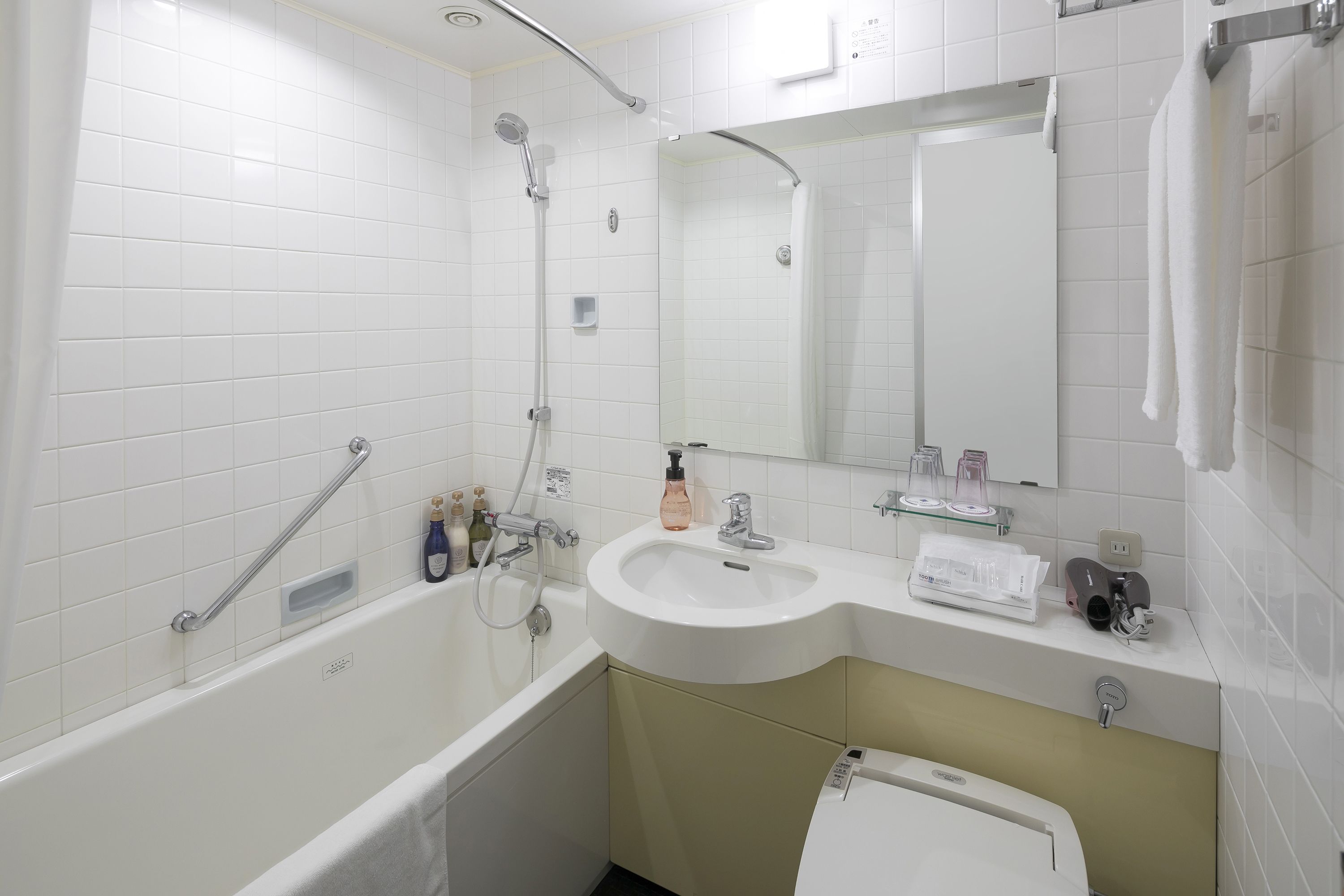 A modern bathroom with a bathtub, a sink, and a shower.