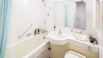 Un baño moderno con bañera, lavamanos e inodoro.
