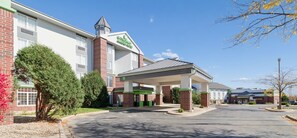 A hotel with a covered entrance, a brick facade, and a clear sky. - Wyndham Garden Madison Fitchburg (Madison)