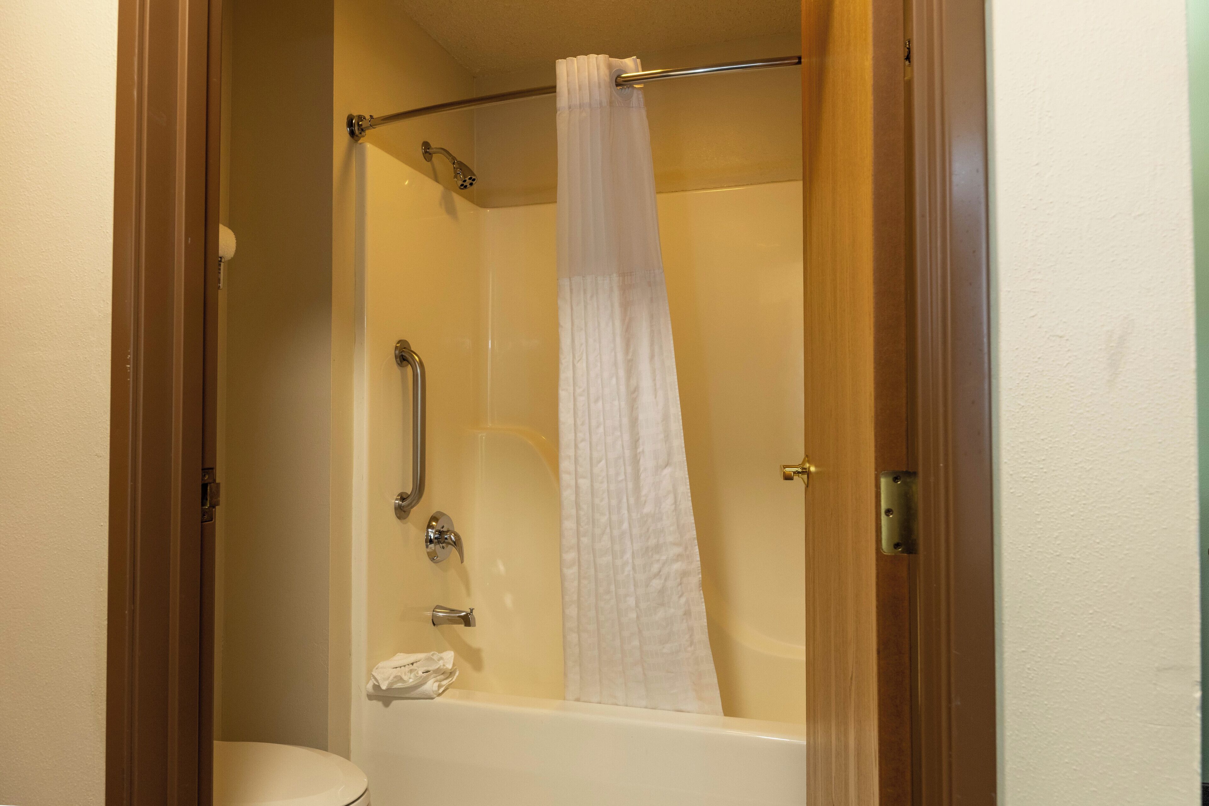 A bathroom with a bathtub, a shower, and a toilet.