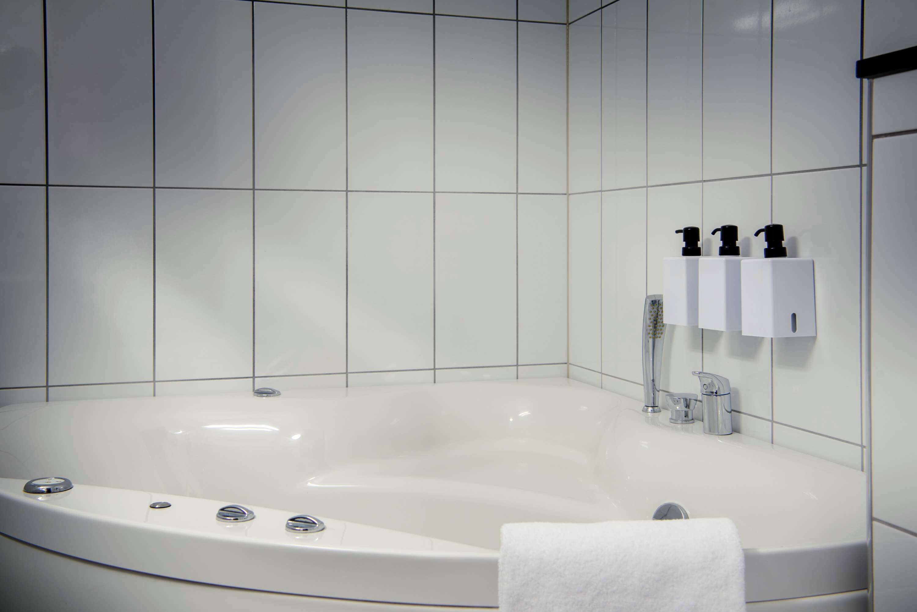 junior suite | bathroom | shower, hair dryer, towels