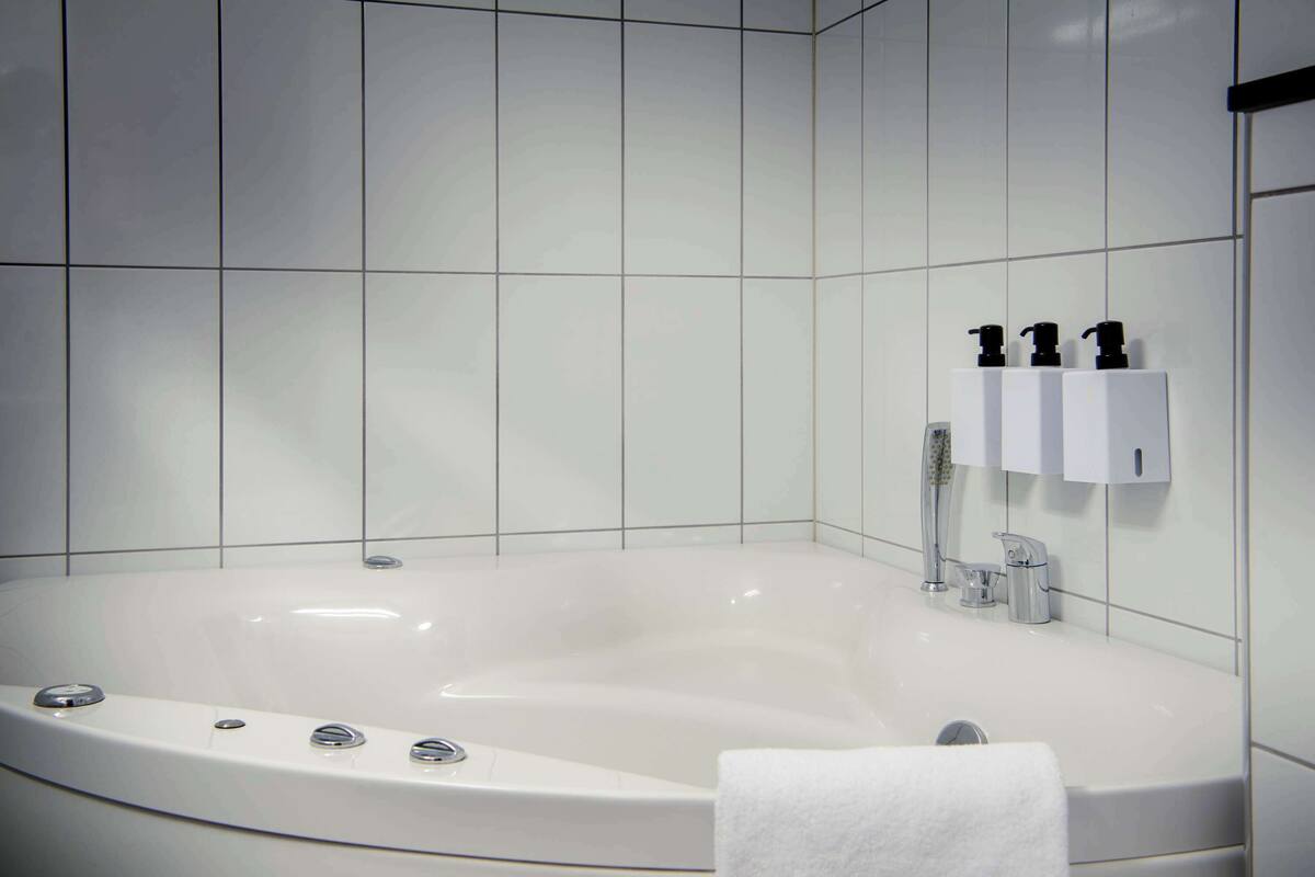 junior suite | bathroom | shower, hair dryer, towels