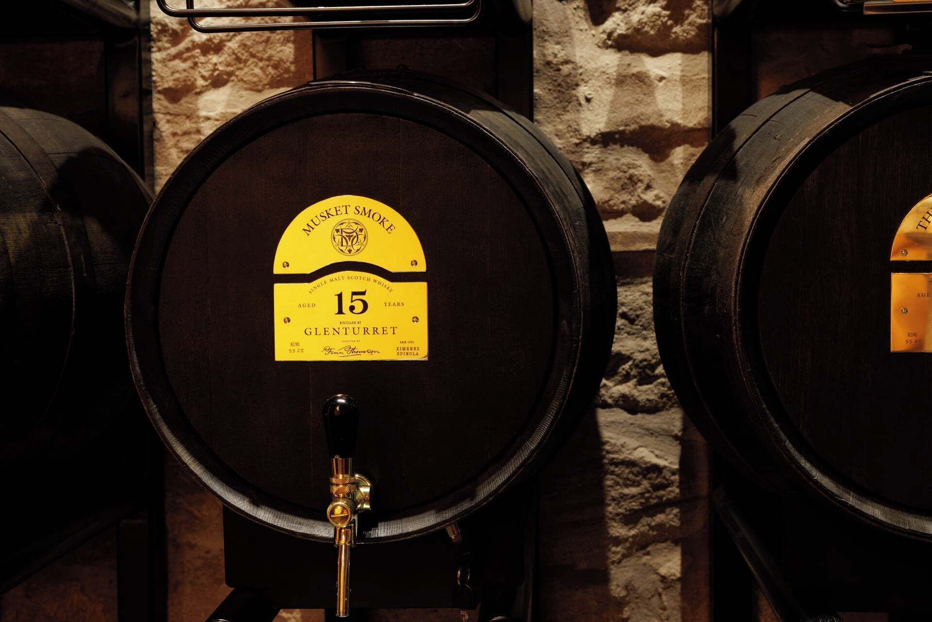 A barrel with a label indicating it is a 15-year-old single malt scotch whisky from Glenturret.