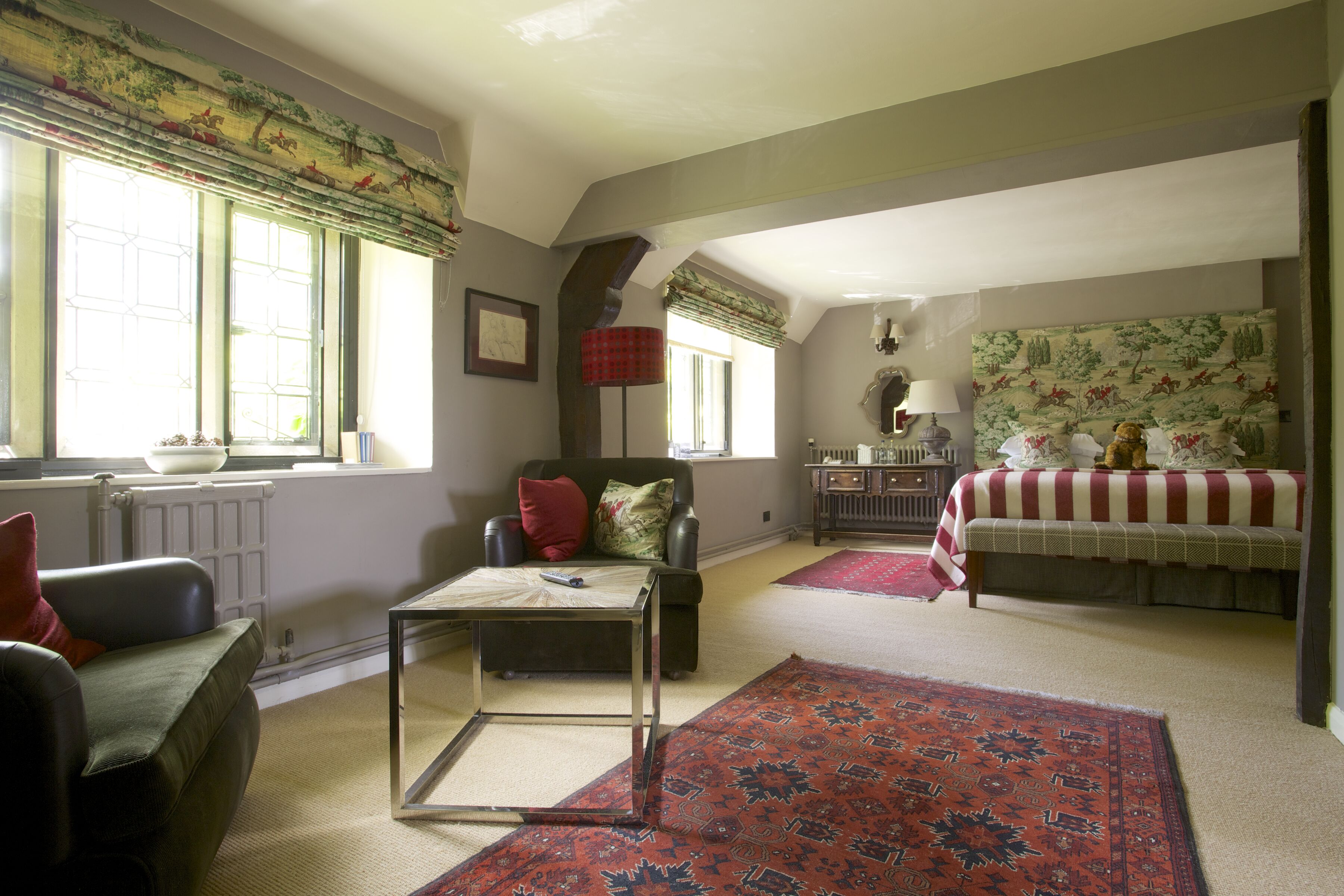 A spacious living room with a sofa, a coffee table, and a patterned rug.