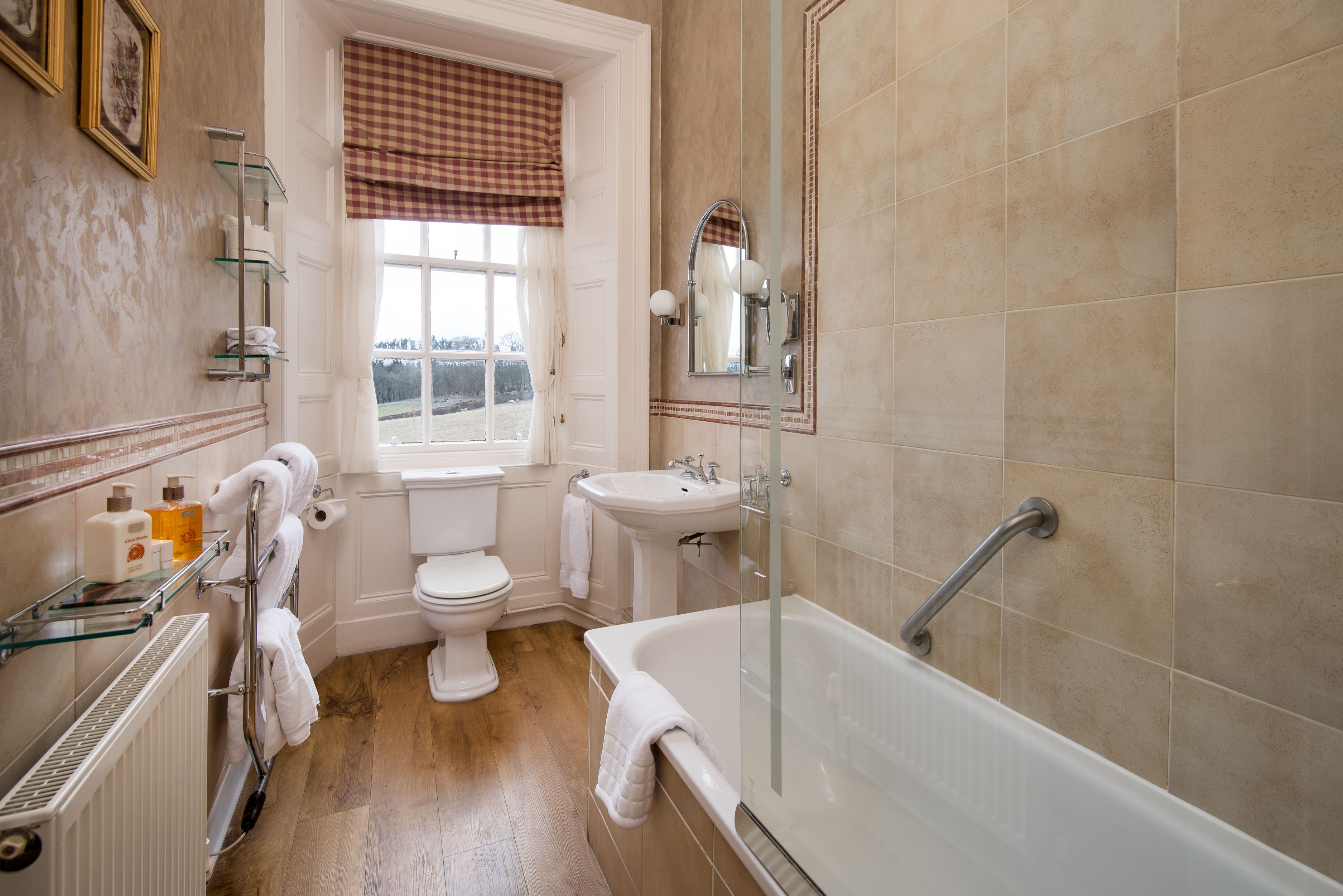 A bathroom with a toilet, sink, and bathtub.