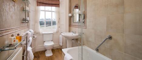 A bathroom with a toilet, sink, and bathtub.