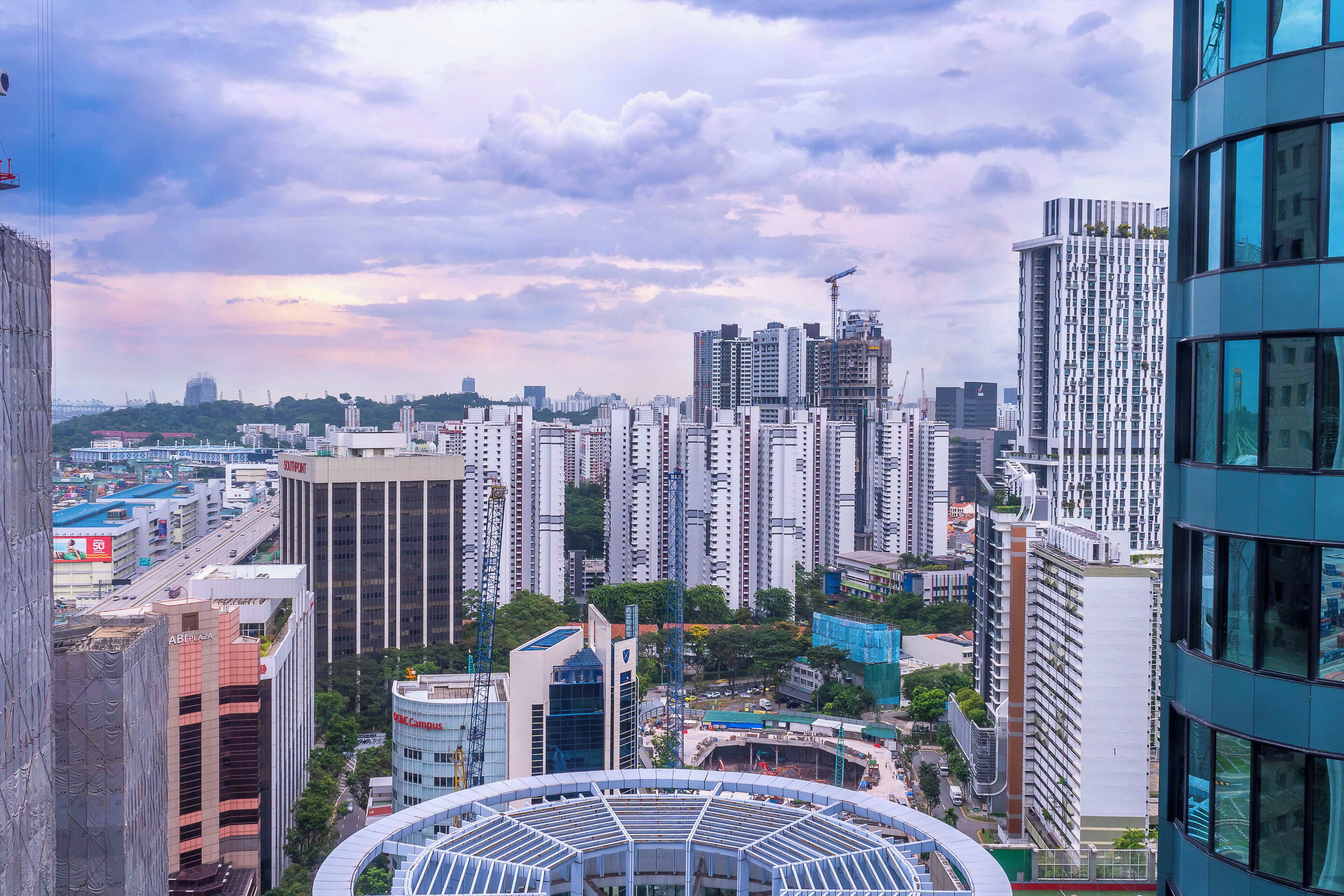 A high-rise urban area with multiple buildings, including a prominent curved structure in the foreground.