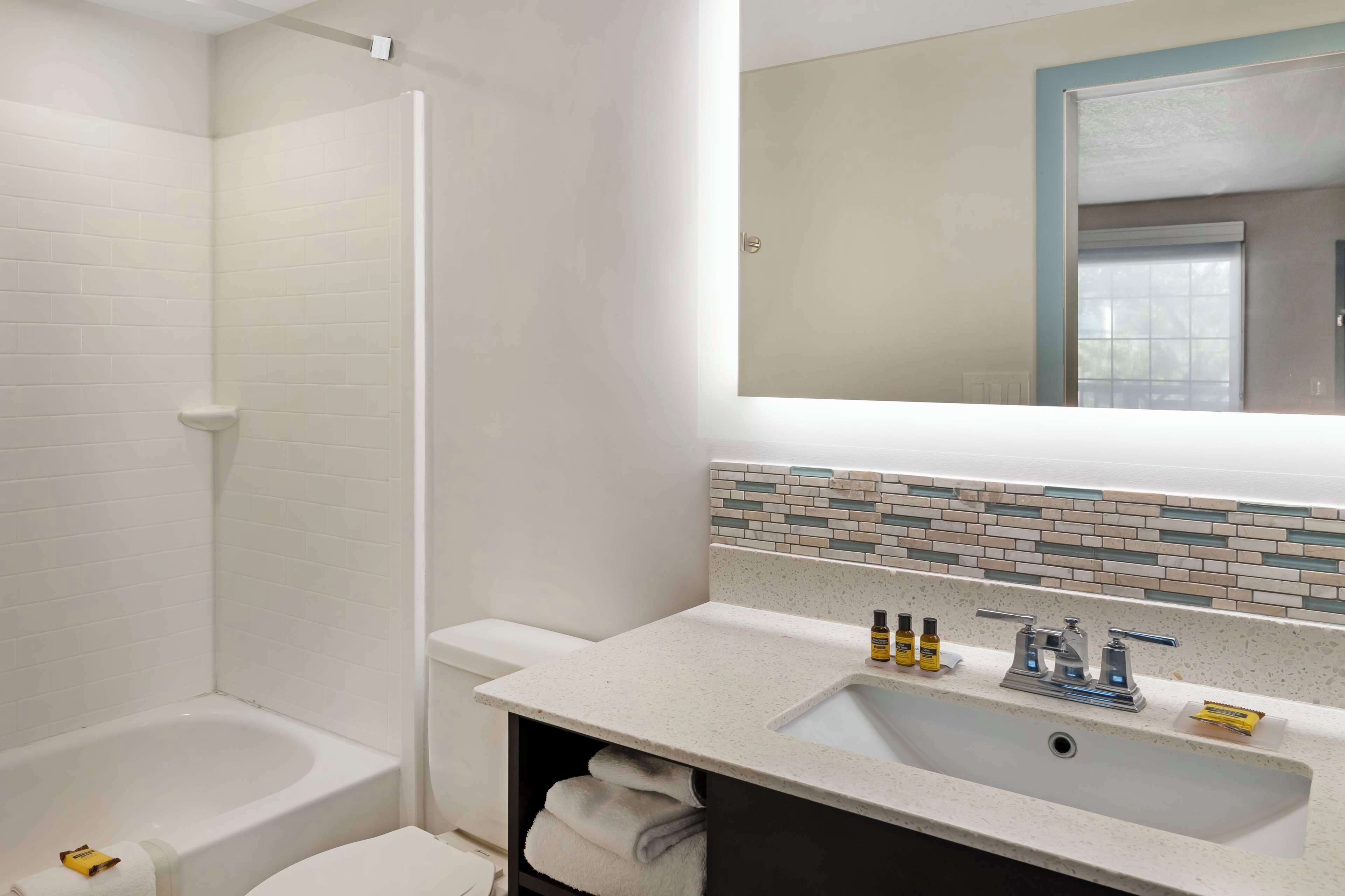 suite, 1 king bed, non smoking, refrigerator | bathroom | combined shower/bathtub, free toiletries, hair dryer, towels
