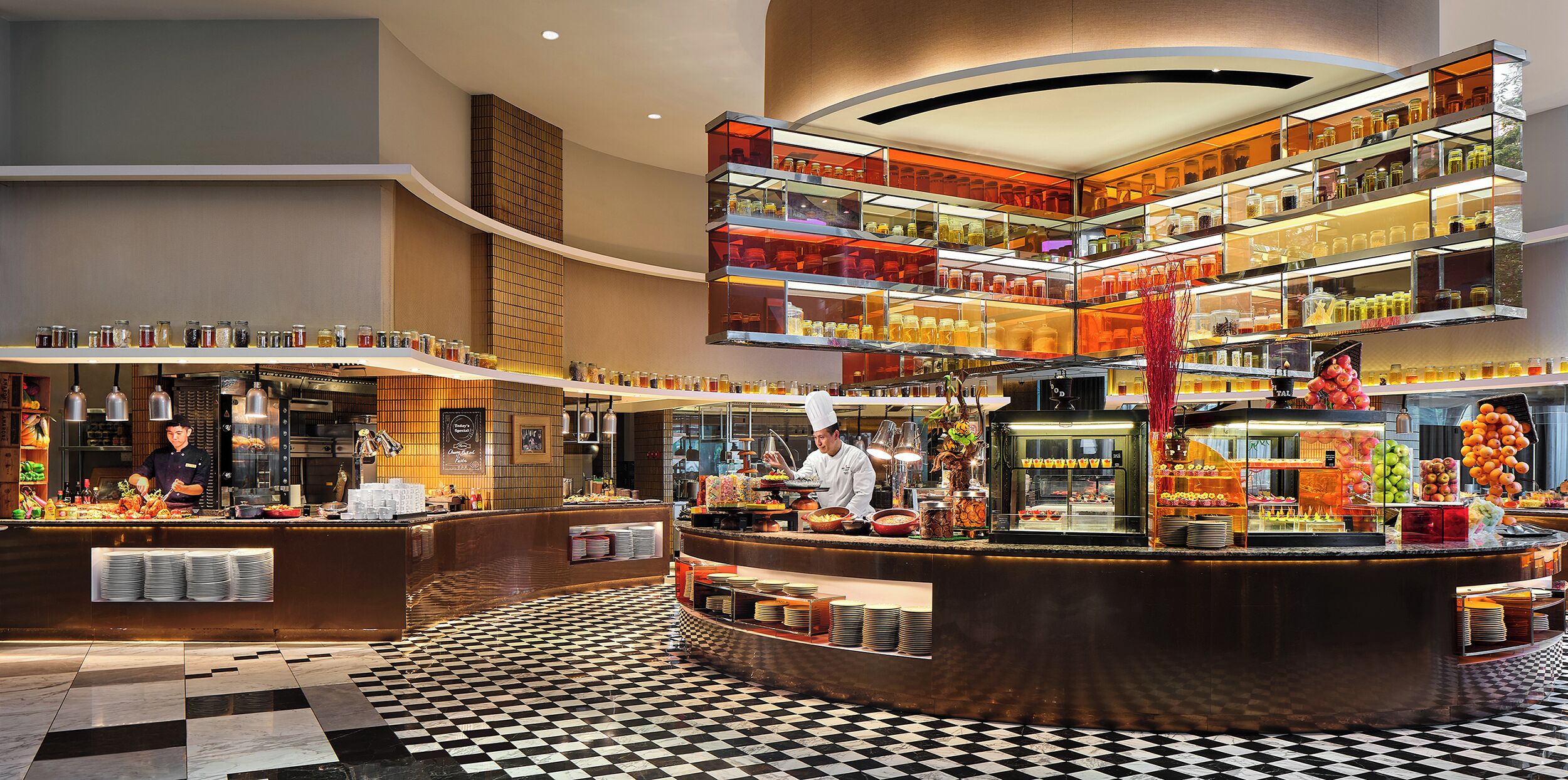 A multi-level buffet with various food items and a check-in counter.