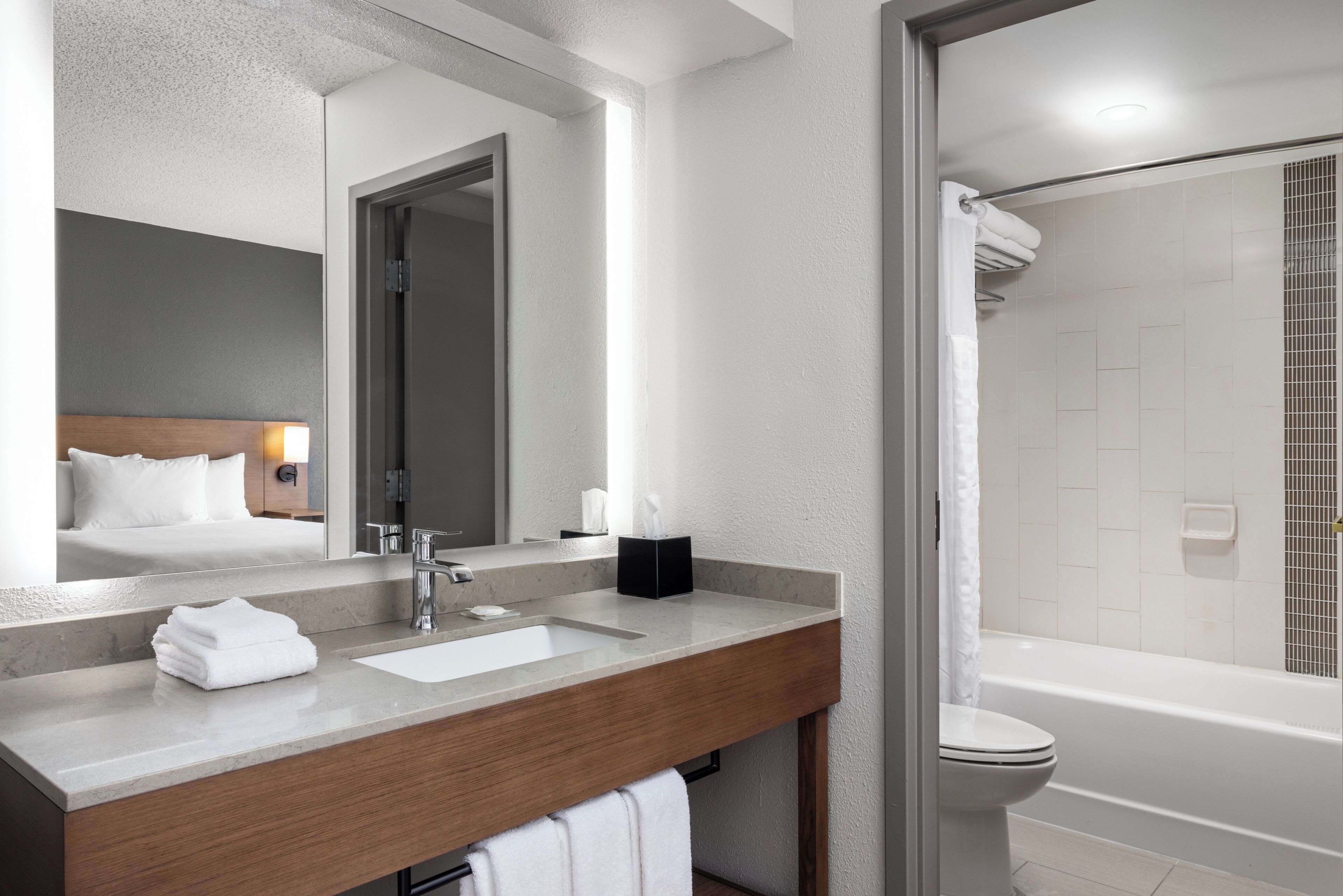 Shower, designer toiletries, hair dryer, towels