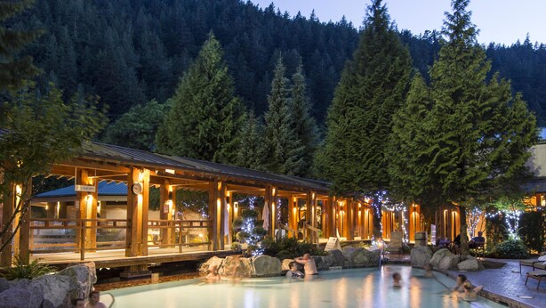A heated outdoor pool area with wooden structures and large rocks. - Harrison Hot Springs Resort and Spa (Harrison Hot Springs)
