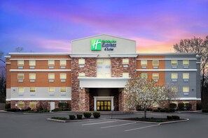 A Holiday Inn Express hotel with a brick facade, large windows, and a parking lot. - Holiday Inn Express & Suites - North Carmel / Westfield by IHG (Carmel)