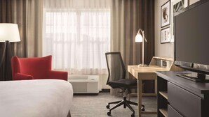 A hotel room with a bed, a desk, a chair, a TV, and a window with curtains. - Country Inn & Suites by Radisson, Dubuque, IA (Dubuque)