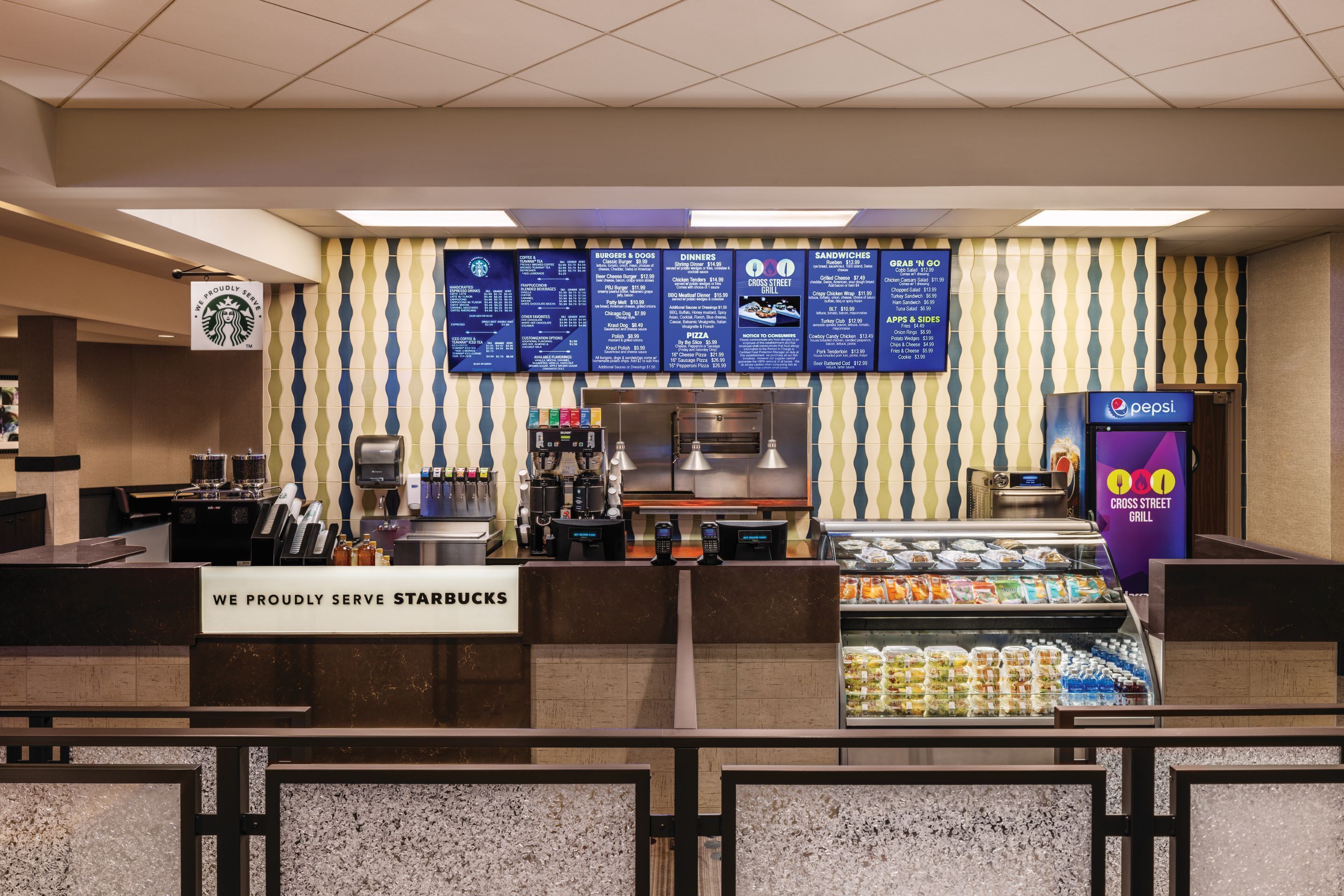 A restaurant area with a menu board, a Starbucks sign, and a Pepsi refrigerator.