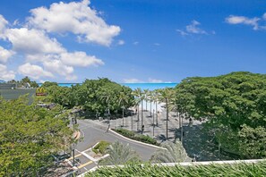 A parking lot with a McDonald's sign, surrounded by trees and a clear sky. - Mantra Esplanade (Cairns)