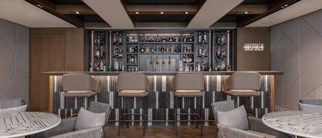 A bar area with a modern design, featuring a bar counter, multiple seating options, and a variety of bottles displayed on shelves.