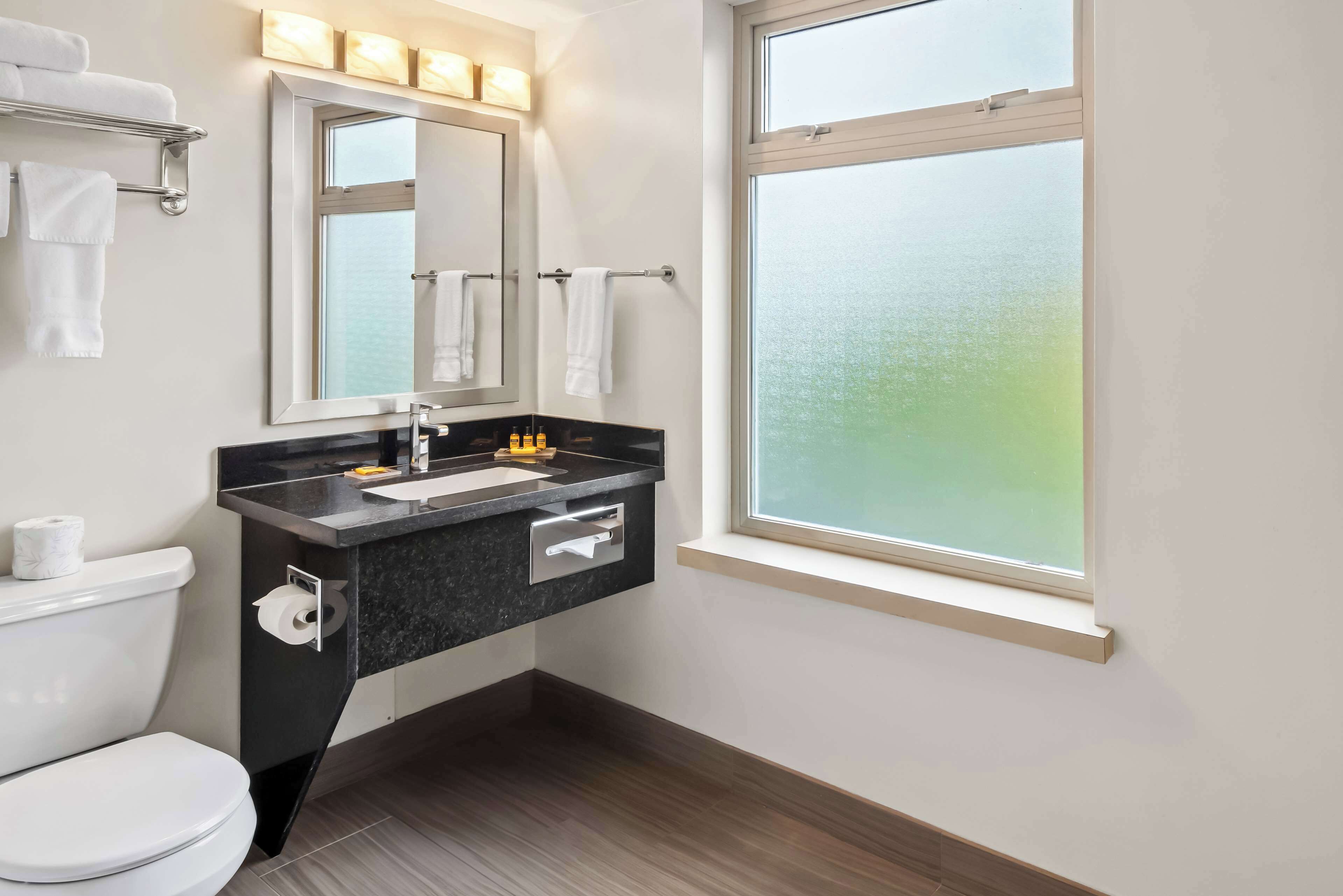 suite, 1 king bed, non smoking, refrigerator & microwave | bathroom | combined shower/bathtub, free toiletries, towels