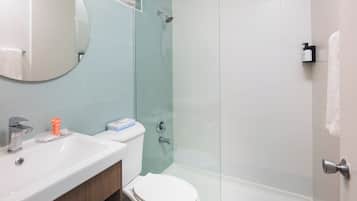 A modern bathroom with a sink, toilet, and shower area.
