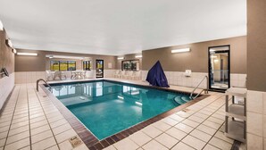 An indoor swimming pool with clear water, surrounded by tiled walls and a ceiling with recessed lighting. - Quality Inn Des Moines North (Des Moines)