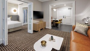 A modern hotel room with a bed, a TV, a dining area, and a sofa. - The Sebel Melbourne Flinders Lane (Melbourne)