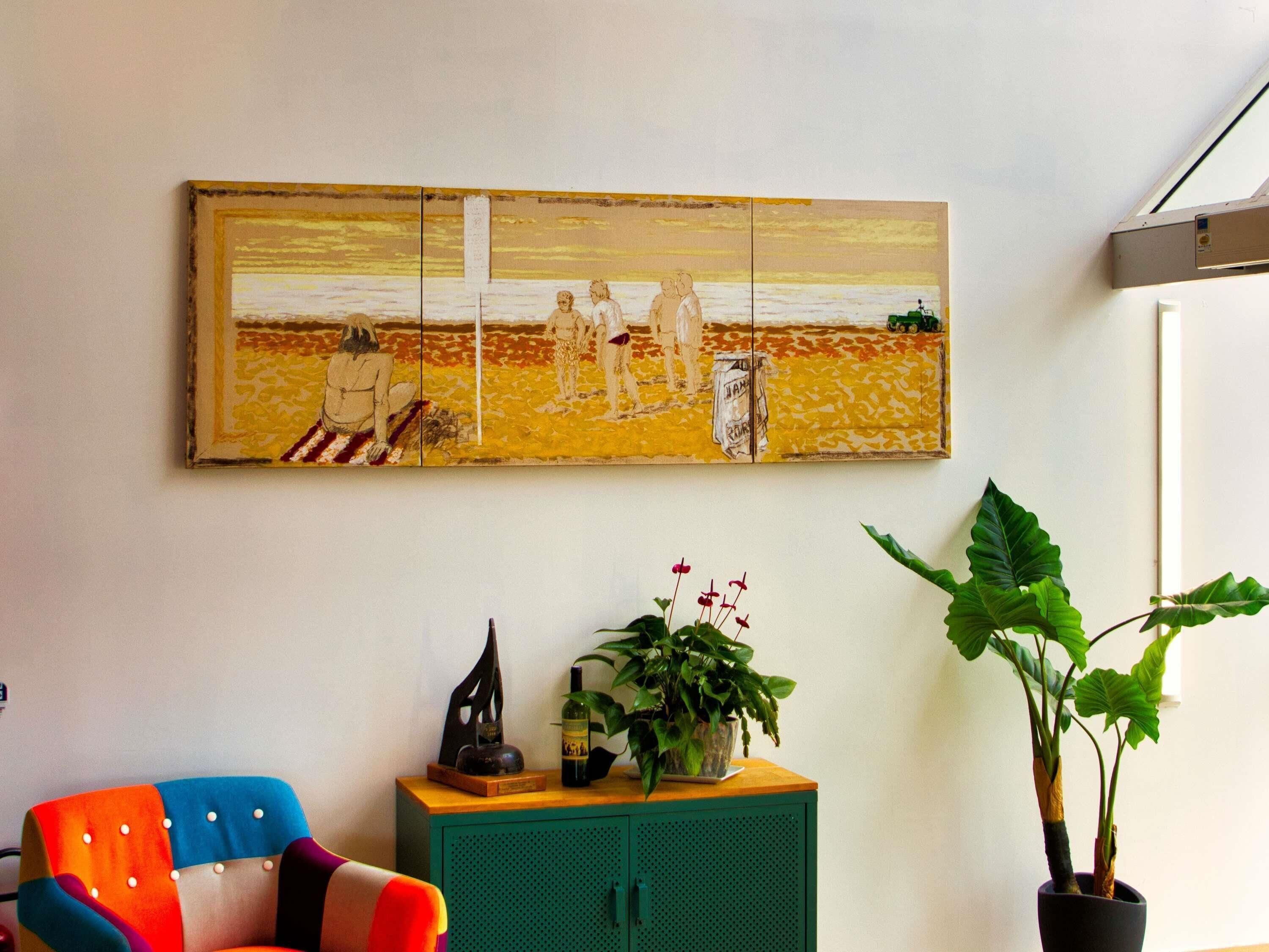 A room with a colorful chair, a green cabinet with decorative items, and a large painting on the wall.