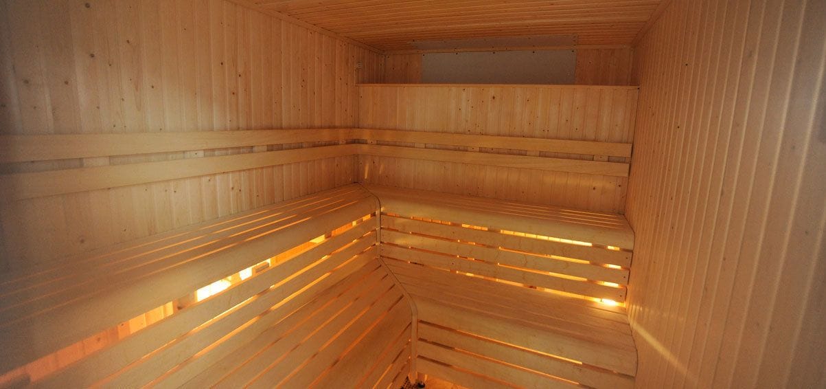 A sauna with wooden benches and slatted walls.