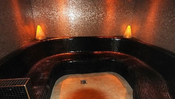 Relax in a spacious hot tub with a drain in the center.