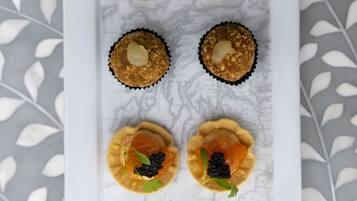 A white rectangular plate with six food items arranged in two rows of three.