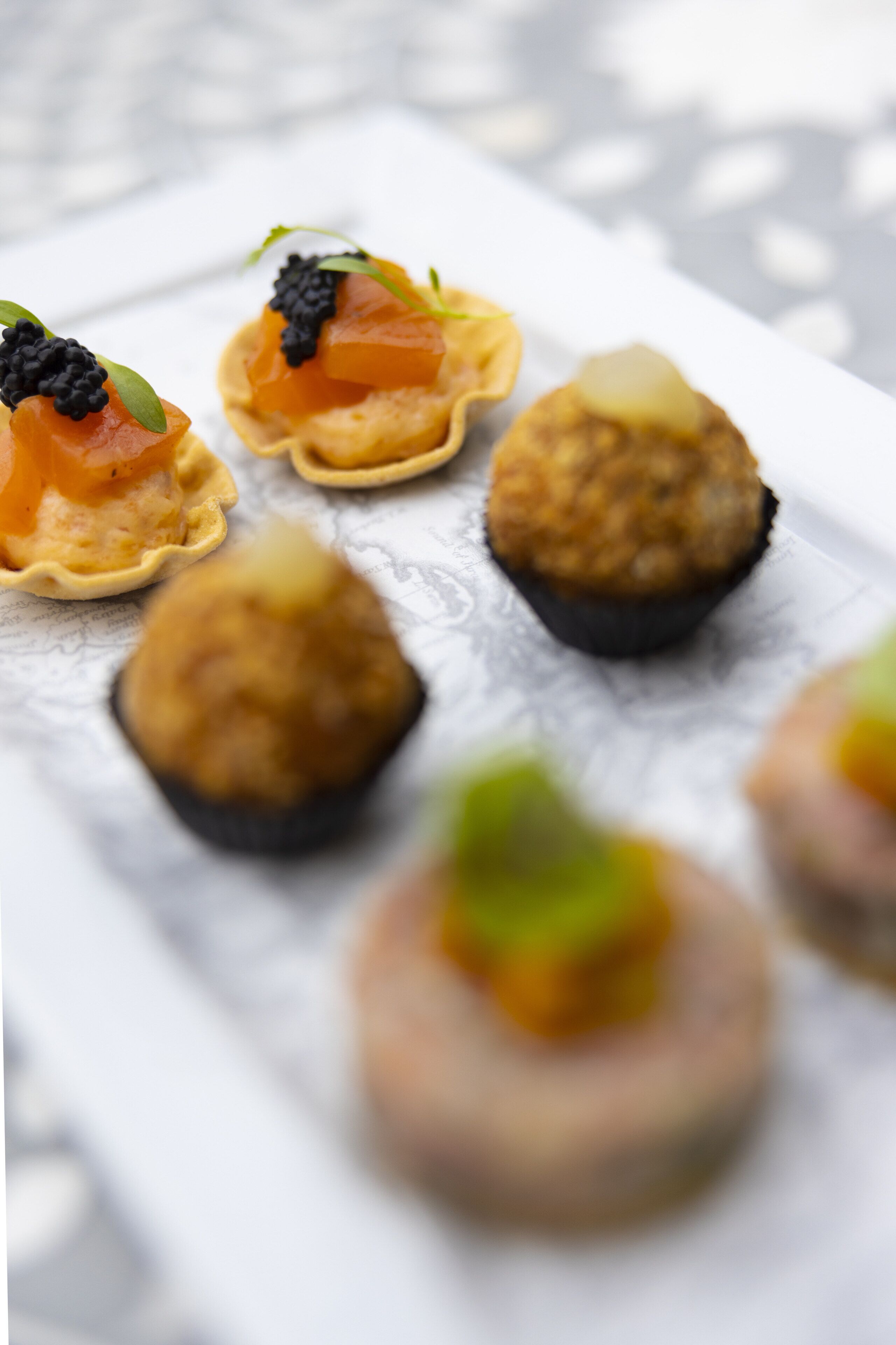 A variety of appetizers on a white plate.