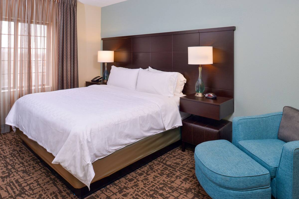 Premium bedding, desk, laptop workspace, blackout curtains