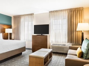 Premium bedding, desk, laptop workspace, blackout drapes