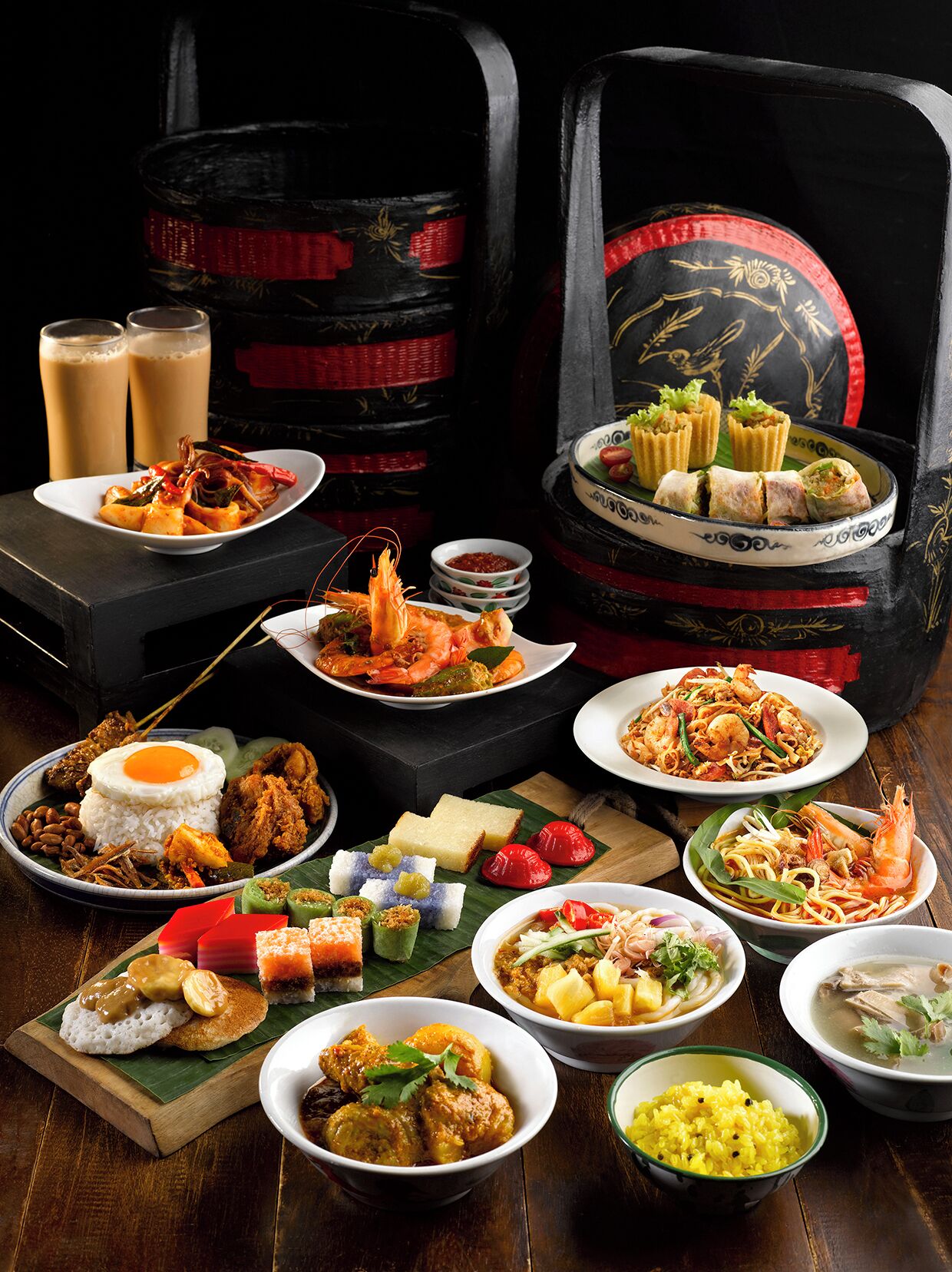 A variety of dishes including seafood, rice, and desserts, arranged on a wooden table.