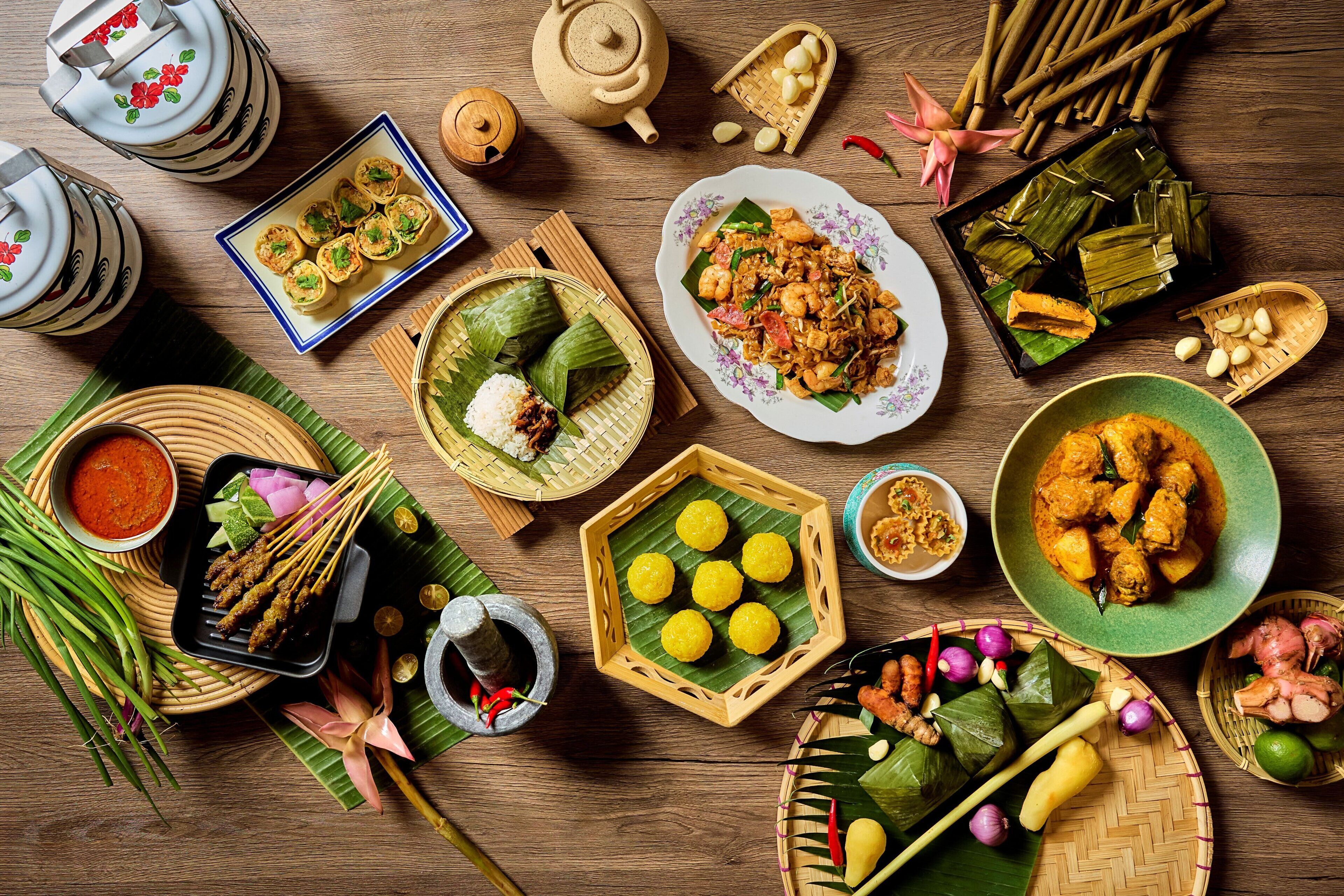 A variety of traditional dishes and food items arranged on a wooden table.