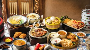 A variety of dishes and food items arranged on a table, suggesting a meal setting.