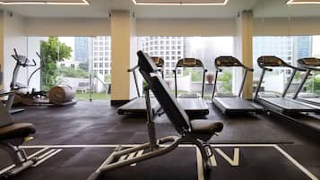A gym with treadmills, elliptical machines, and weight equipment.