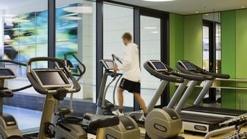 A gym with treadmills and exercise equipment.