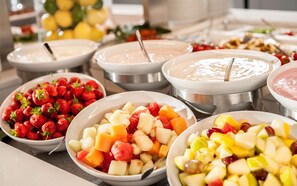 A buffet with various fruit and dessert options. - Essential by Dorint Köln - Junkersdorf (Cologne)