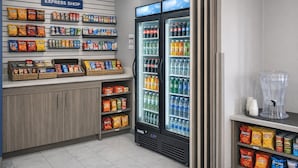 A grocery store with an express shop, snack aisles, and refrigerated beverages.