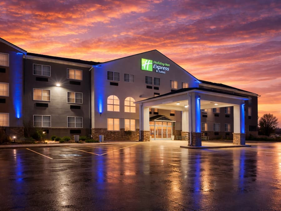 Un bâtiment de l’hôtel Holiday Inn Express doté d’une entrée abritée, de grandes fenêtres et d’un parking.