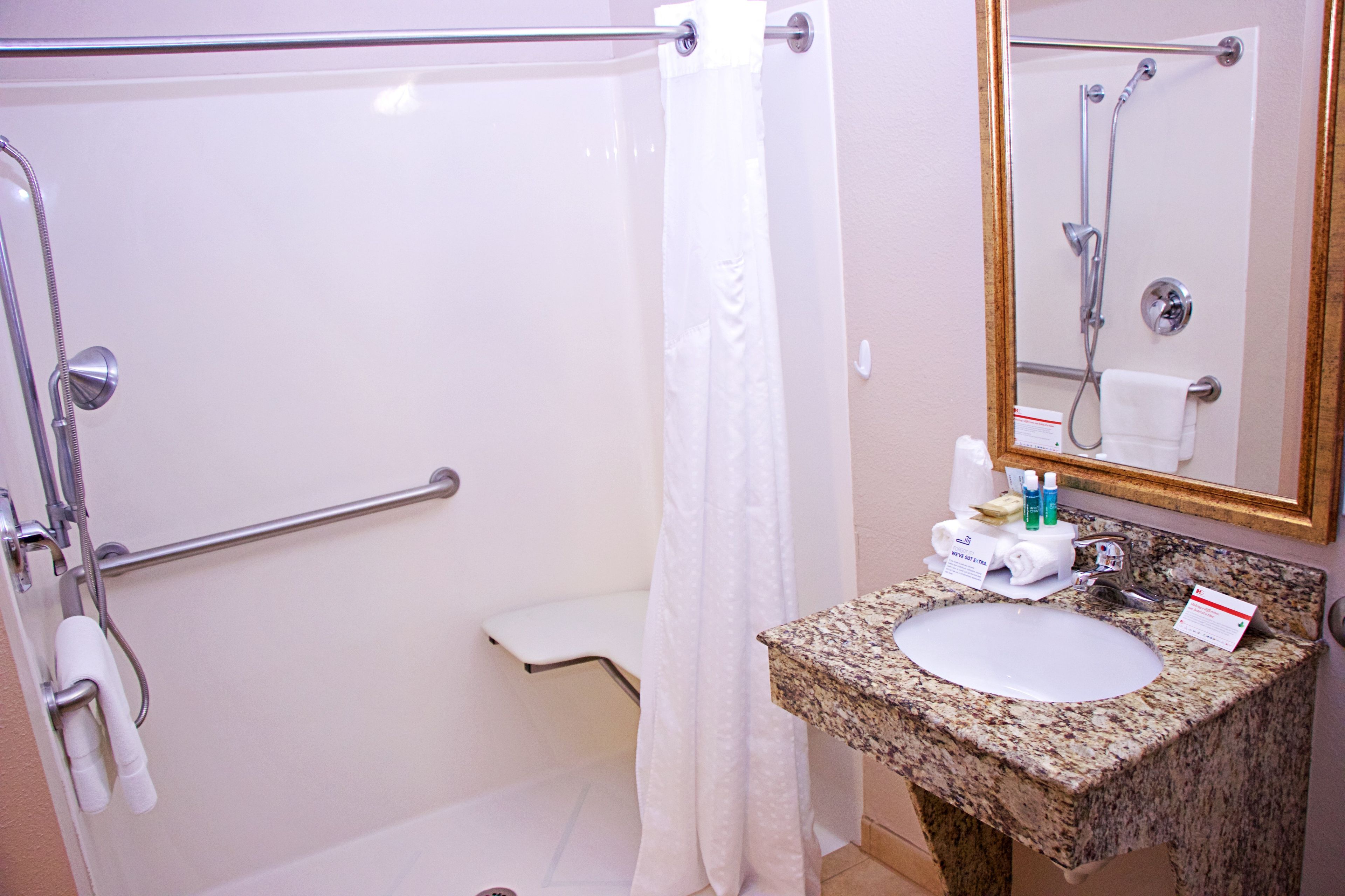 A bathroom with a shower, toilet, and sink.