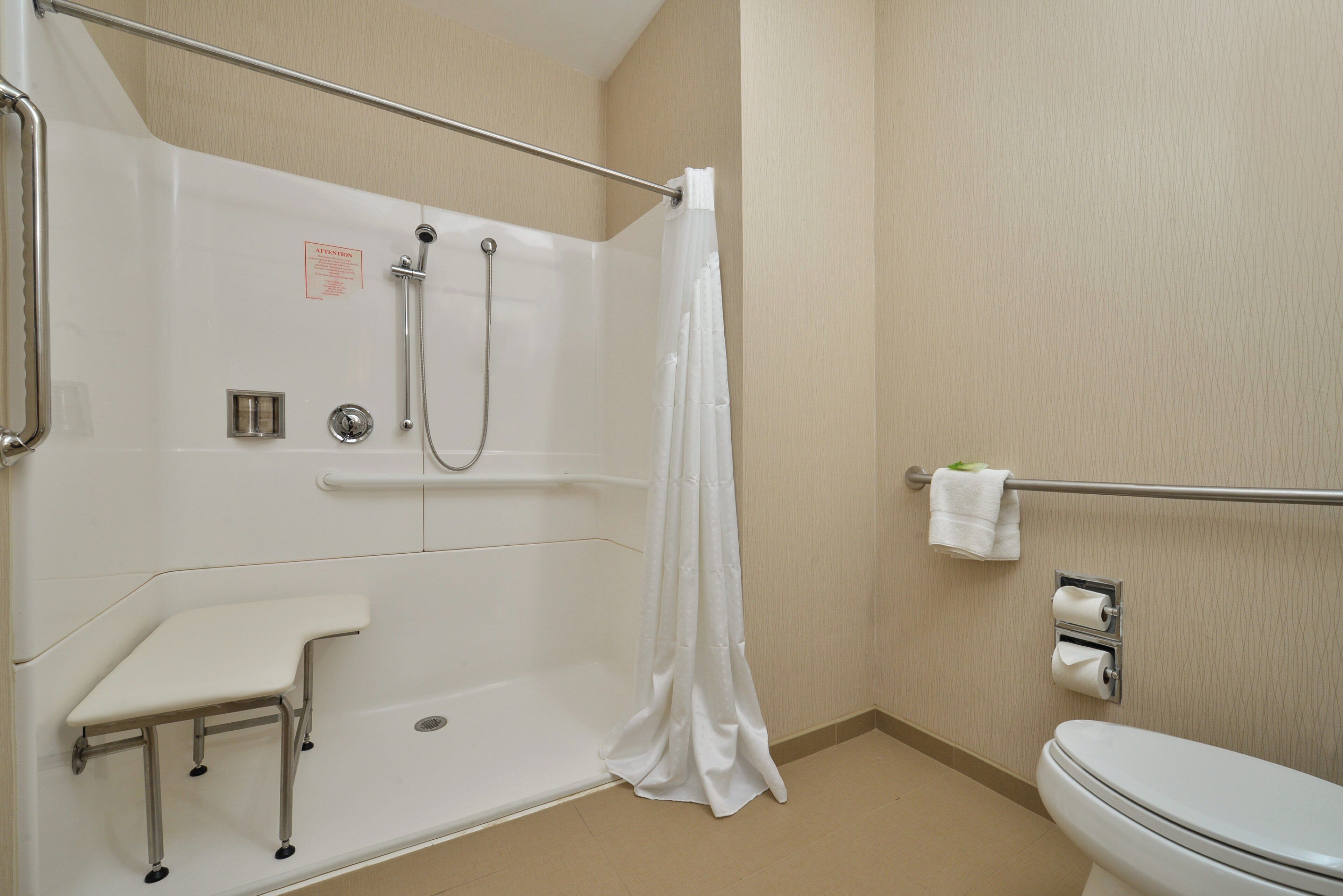 A bathroom with a shower, toilet, and sink.