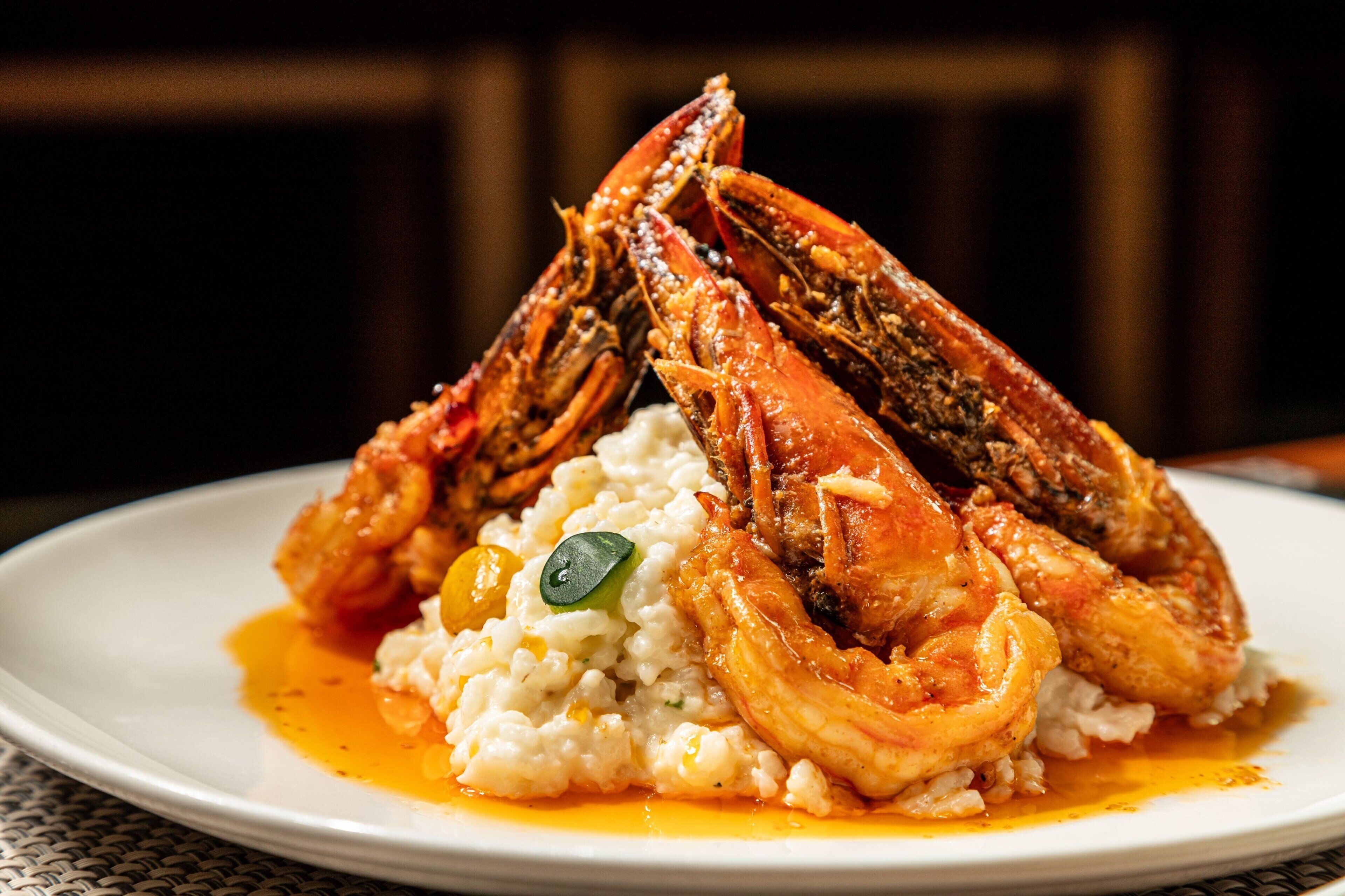 A plate with two cooked crabs and a serving of rice.
